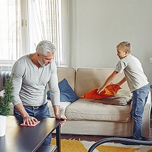 Man and boy cleaning their house